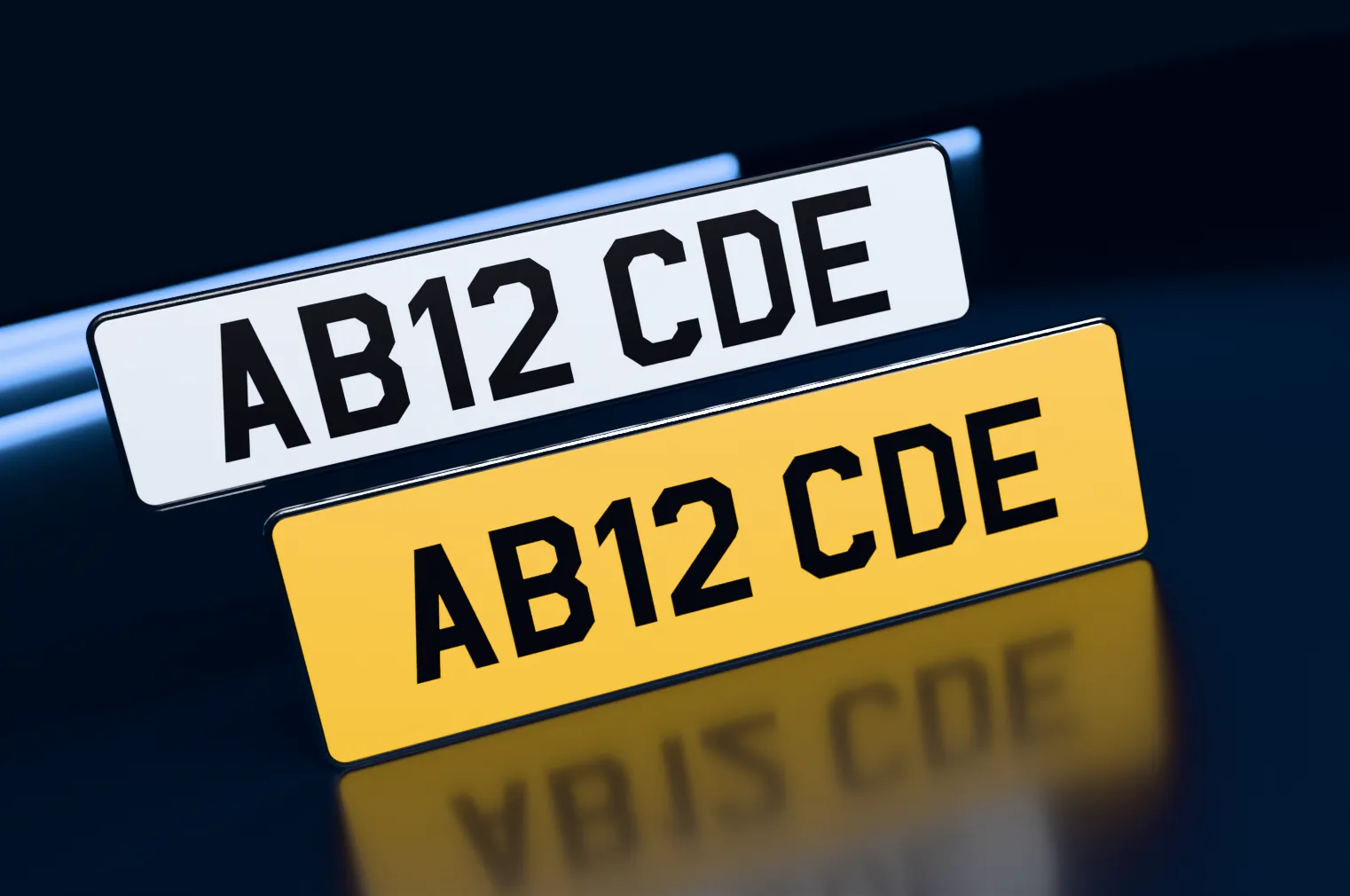 A white front and a yellow rear oversized number plate with printed black characters