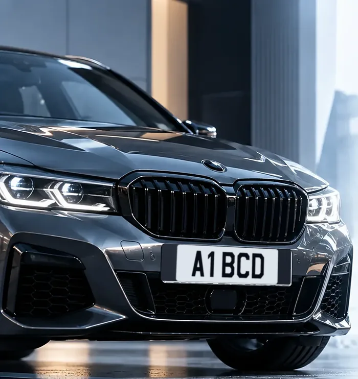 A grey car fitted with a white short number plate reading A1 BCD